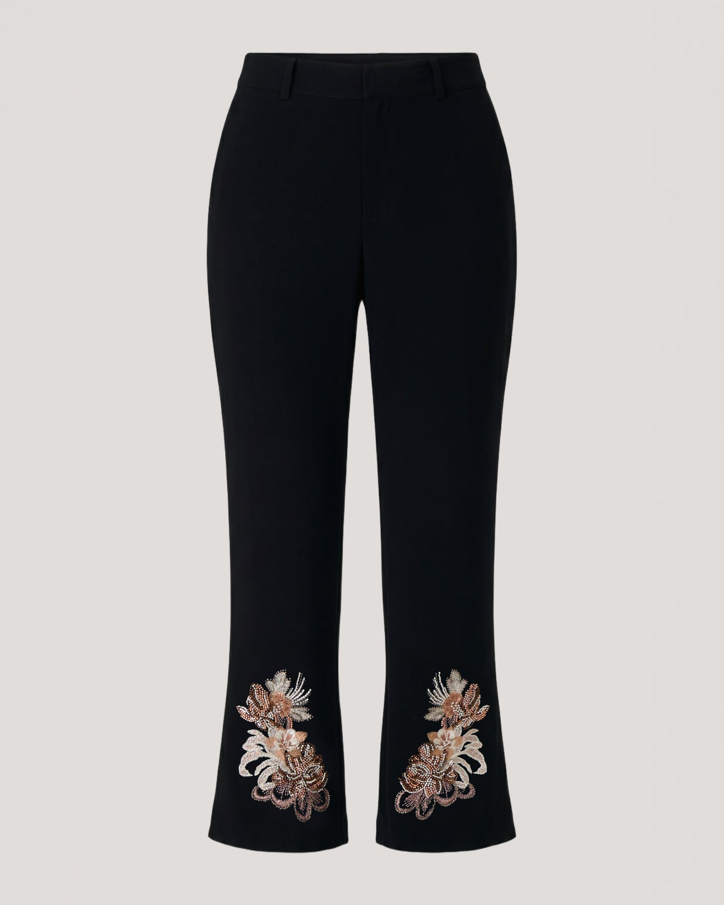 Black cropped trousers with ornate floral embroidery near the hem, shown against a light gray background.