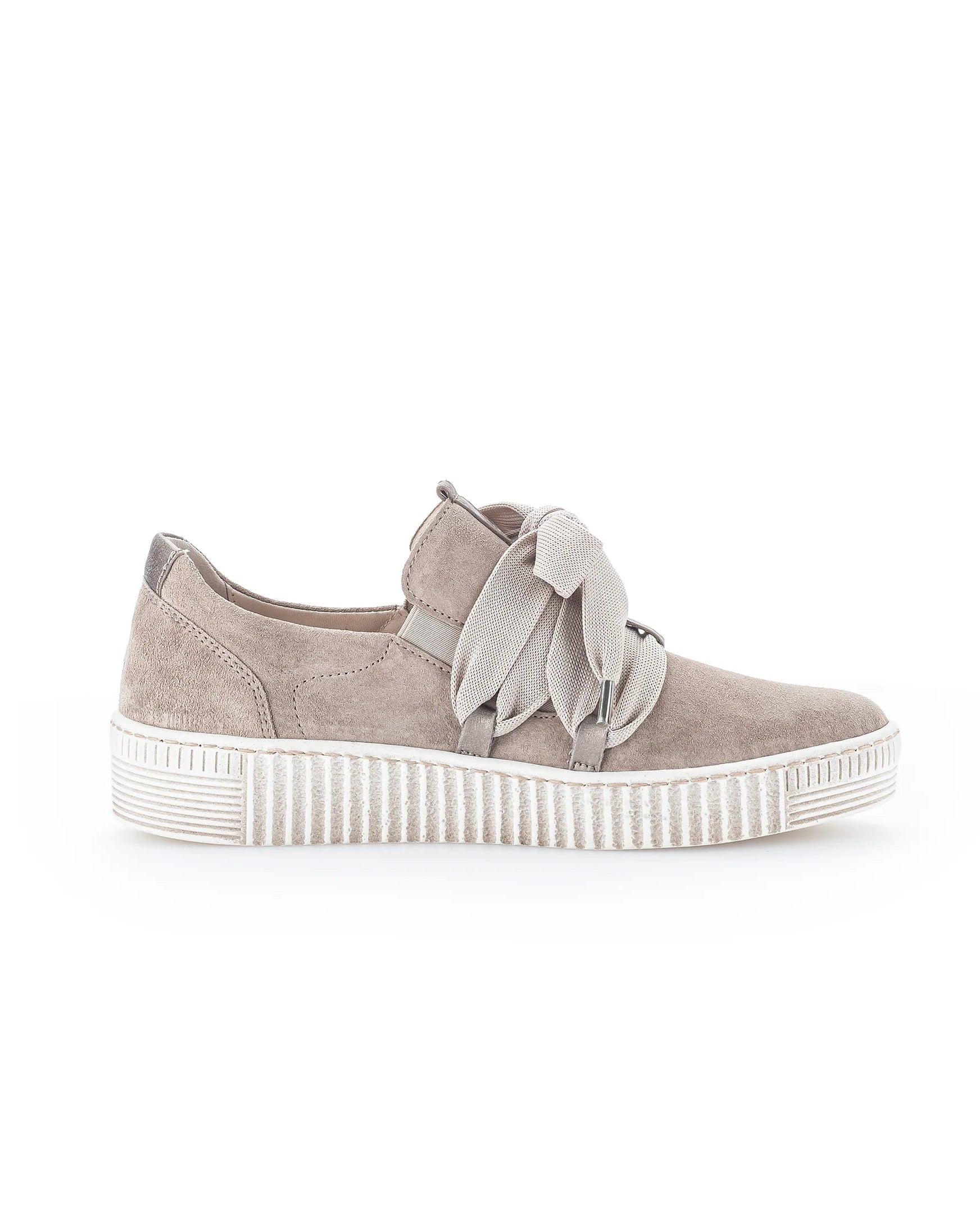 A single light taupe suede slip-on sneaker with a decorative fabric bow detail on the side and a thick, ribbed white platform sole, shown against a plain white background.